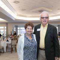 Ron Clark standing with other guest and posing for camera